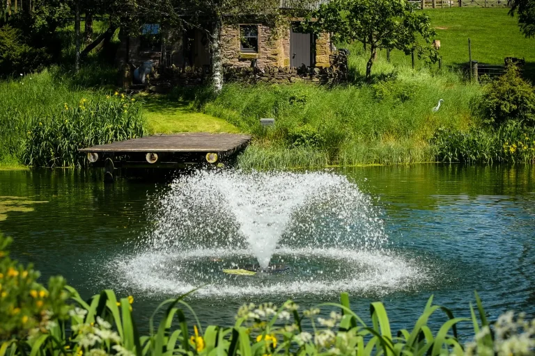 Loch with fountain overlooking the Whisky Howf at Craighead Howfs in Perthshire, Scotland